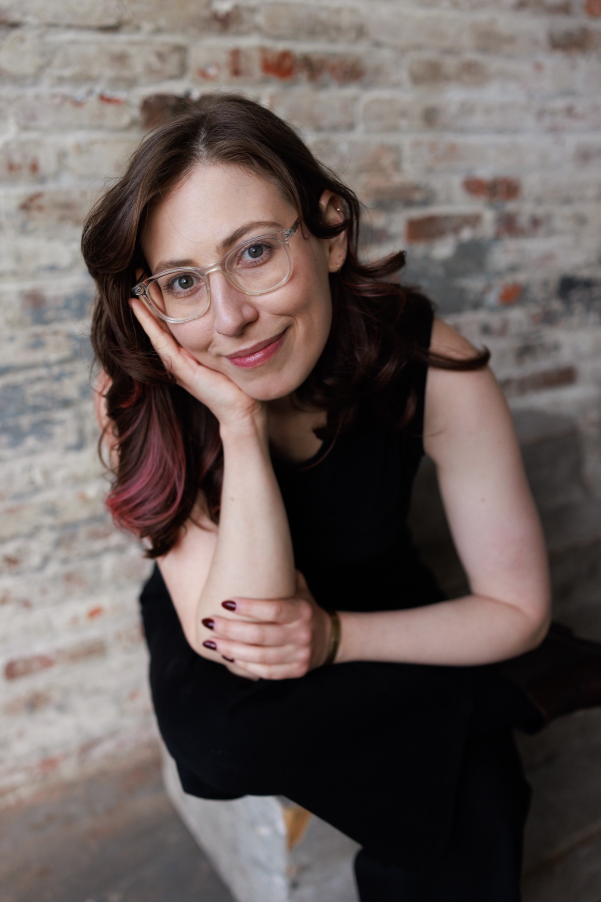 Alberta Devor seated in front of a brick wall